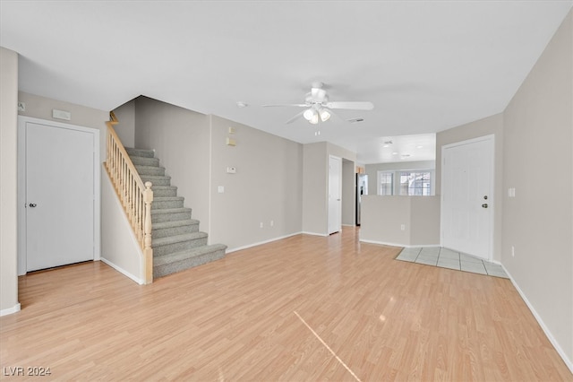 unfurnished living room with ceiling fan and light hardwood / wood-style floors