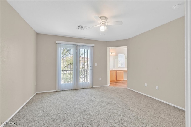 unfurnished room featuring light carpet and ceiling fan