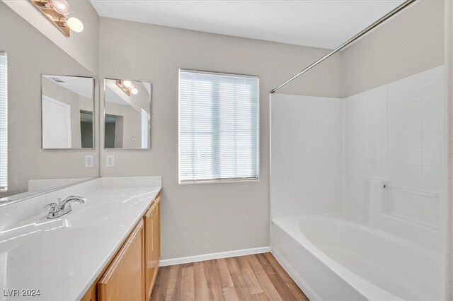 bathroom featuring vanity, shower / bath combination, and hardwood / wood-style floors