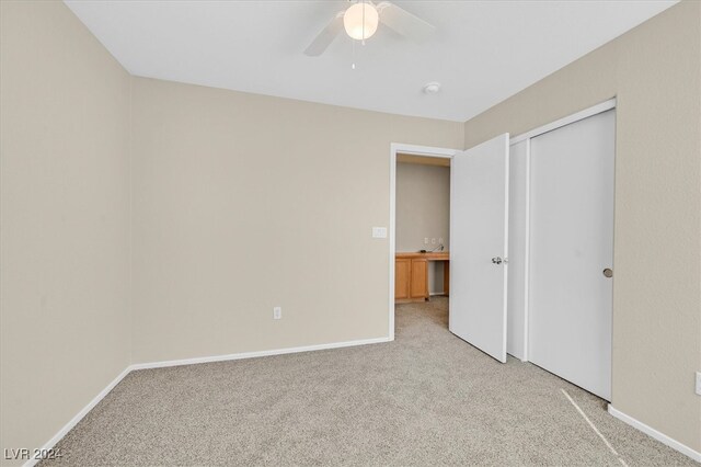 unfurnished bedroom with ceiling fan and carpet flooring