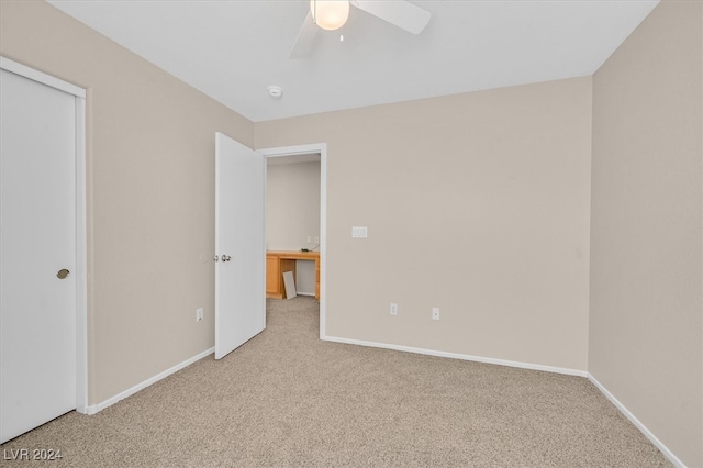 unfurnished bedroom featuring light carpet and ceiling fan