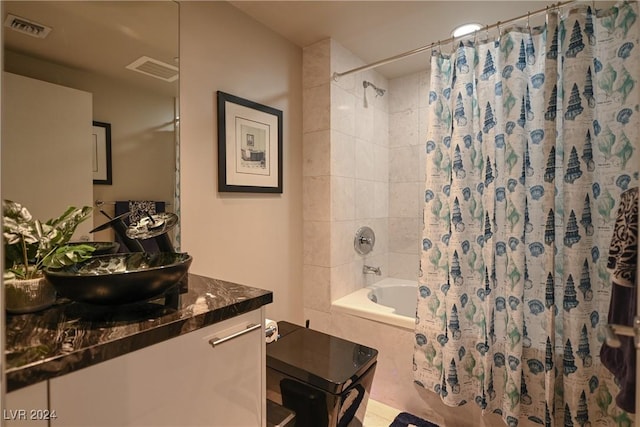 bathroom featuring tile patterned floors, vanity, and shower / tub combo