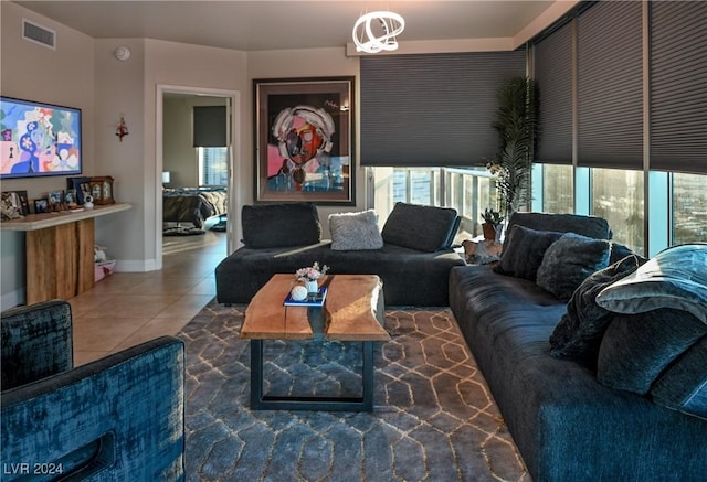 living room with tile patterned flooring and a notable chandelier