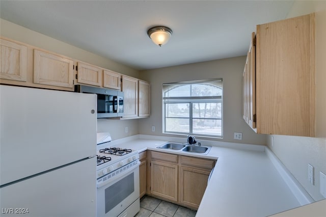 kitchen featuring light brown cabinetry, light tile patterned floors, sink, and white appliances