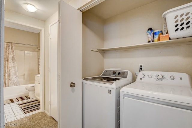 washroom with separate washer and dryer and tile patterned flooring