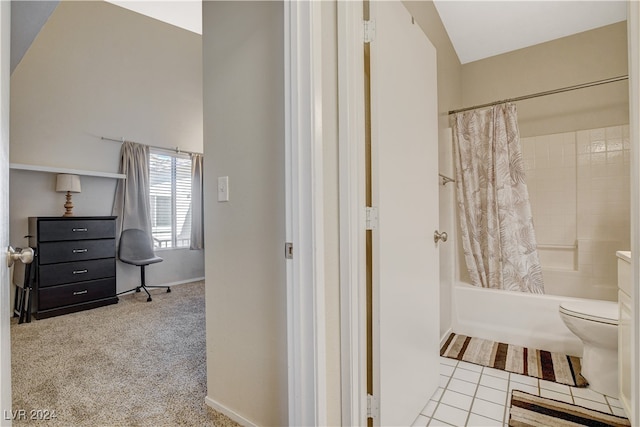 bathroom featuring tile patterned flooring, toilet, and shower / tub combo