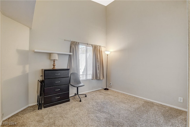 carpeted home office featuring lofted ceiling