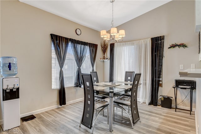 dining room featuring a notable chandelier and light hardwood / wood-style flooring