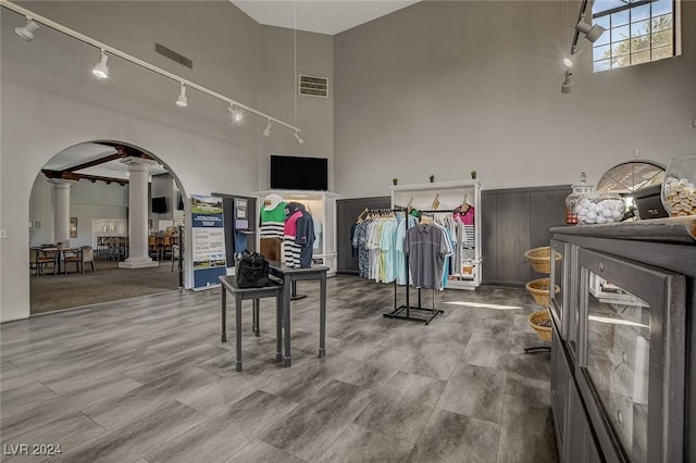 4810 Black Bear Rd Unit 202, Las Vegas, NV 89149 - exercise room featuring decorative columns, arched walkways, rail lighting, and a high ceiling