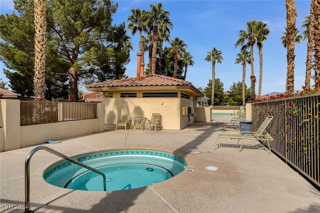 view of pool with a patio and a community hot tub