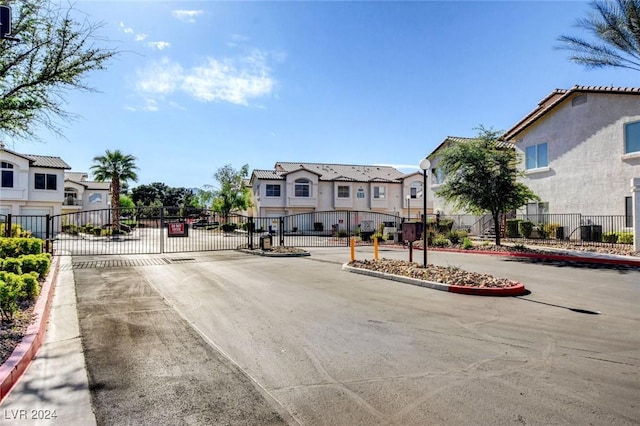 4810 Black Bear Rd Unit 202, Las Vegas, NV 89149 - view of asphalt street with a residential view, a gate, a gated entry, and curbs