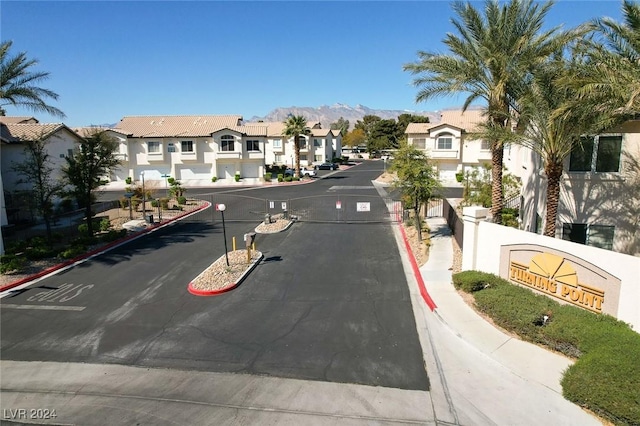 4810 Black Bear Rd Unit 202, Las Vegas, NV 89149 - view of asphalt road with a residential view, curbs, a mountain view, and sidewalks