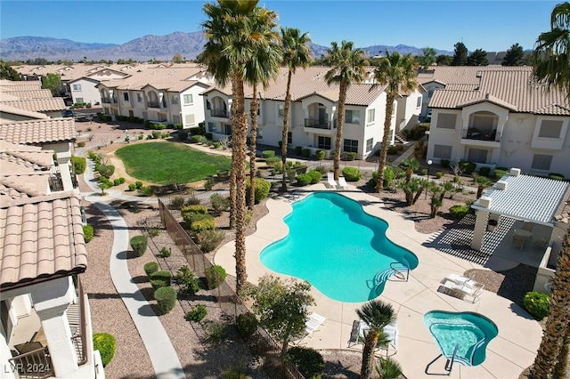 view of pool featuring a patio area and a mountain view