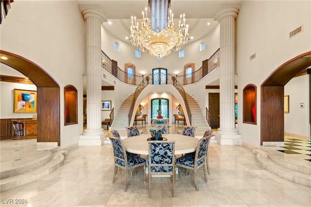 dining area with a high ceiling and decorative columns