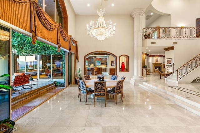 dining room with an inviting chandelier, decorative columns, visible vents, and stairway