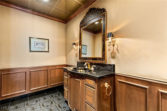 bathroom featuring crown molding, tile patterned flooring, wainscoting, and vanity