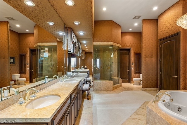 bathroom with toilet, a bidet, and wallpapered walls