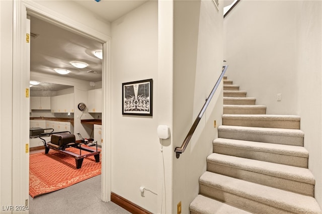 stairs with carpet flooring and baseboards