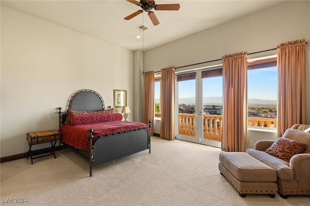 carpeted bedroom with access to outside, a mountain view, and ceiling fan