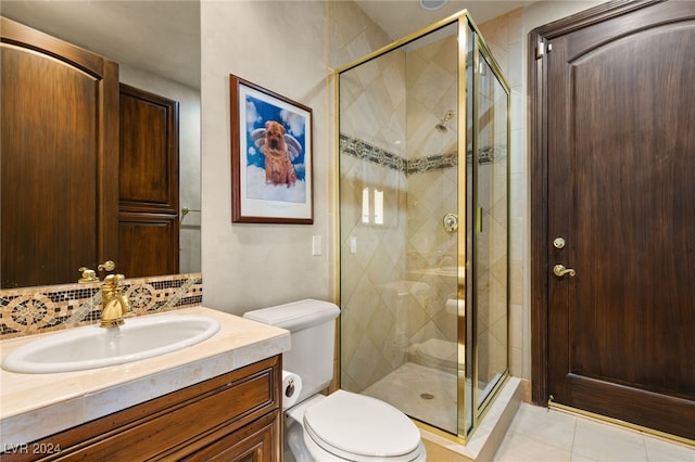 full bathroom featuring vanity, toilet, a stall shower, decorative backsplash, and tile patterned floors