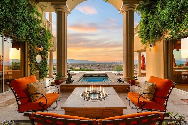 patio terrace at dusk with an in ground hot tub