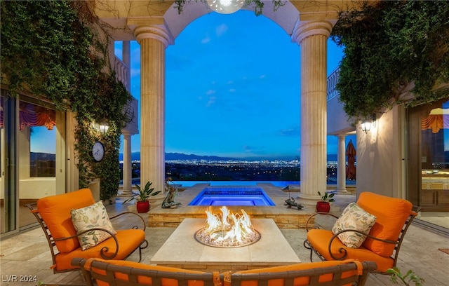 patio terrace at dusk featuring an outdoor fire pit