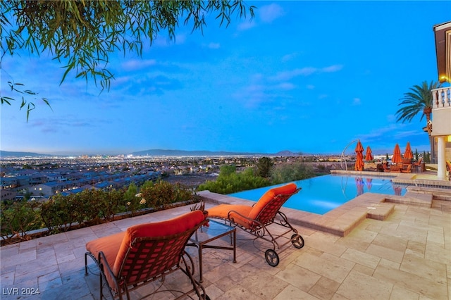 view of pool featuring a mountain view and a patio area