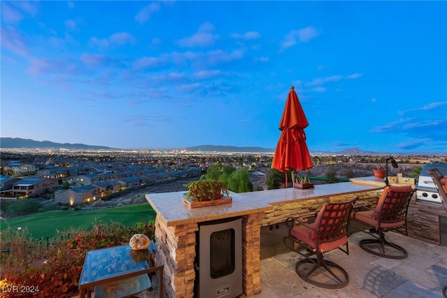 view of patio / terrace with exterior bar and a mountain view