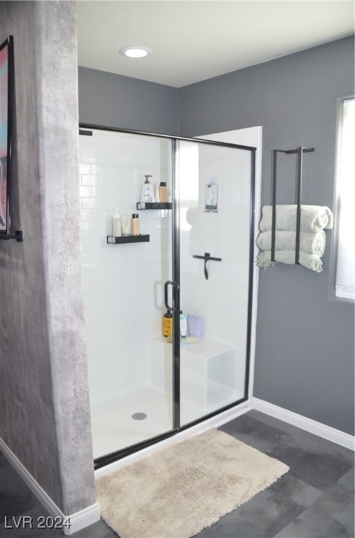 bathroom with a shower with shower door