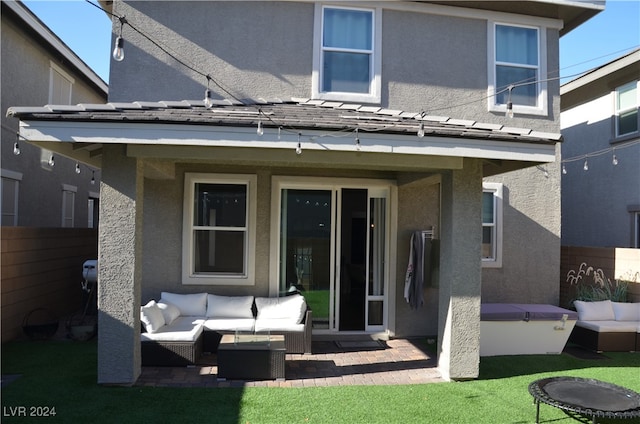 back of house featuring an outdoor hangout area, a yard, and a patio area