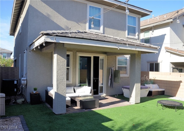 back of house featuring a patio, central AC, a lawn, and an outdoor hangout area