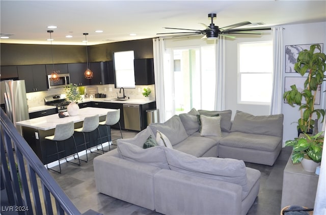 living room with sink and ceiling fan