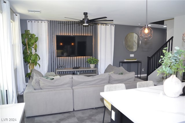 living room featuring concrete floors and ceiling fan