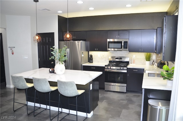 kitchen featuring hanging light fixtures, stainless steel appliances, sink, a center island, and tasteful backsplash