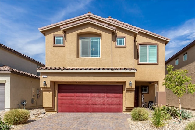 mediterranean / spanish-style home with a garage