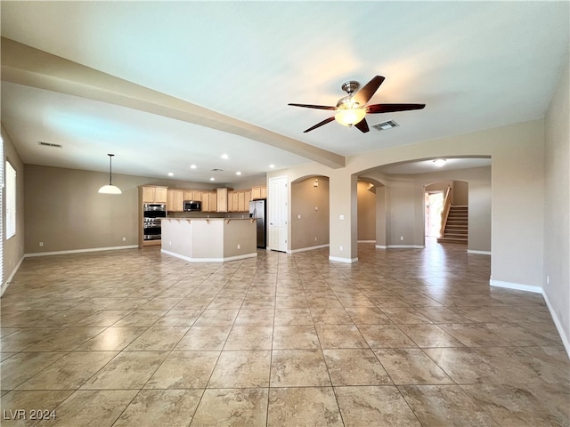 unfurnished living room with ceiling fan