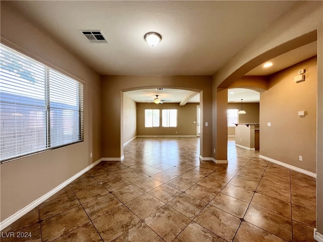 spare room featuring tile patterned floors and ceiling fan