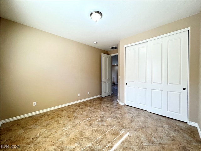 unfurnished bedroom featuring a closet