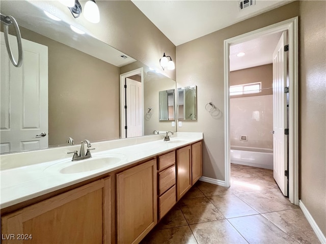 bathroom with bathtub / shower combination, tile patterned floors, and vanity