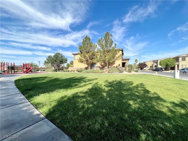 view of front facade with a playground and a front lawn