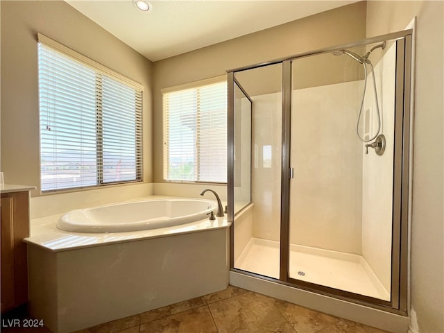 bathroom with tile patterned floors, separate shower and tub, and vanity