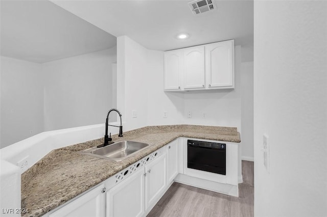 kitchen featuring dishwasher, white cabinets, sink, light hardwood / wood-style flooring, and light stone counters