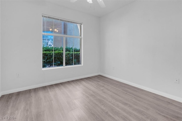 spare room featuring light hardwood / wood-style floors and ceiling fan