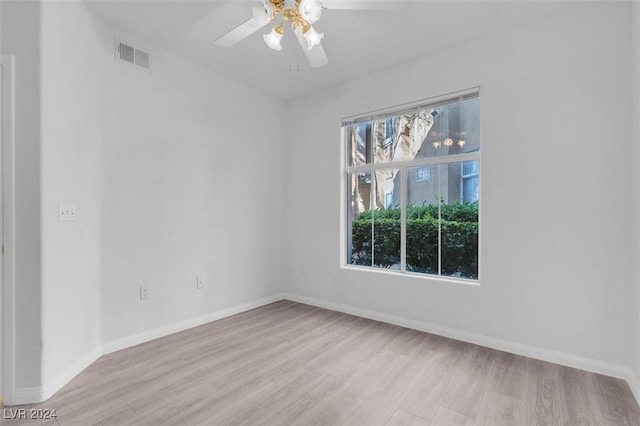 spare room featuring ceiling fan, plenty of natural light, and light wood-type flooring