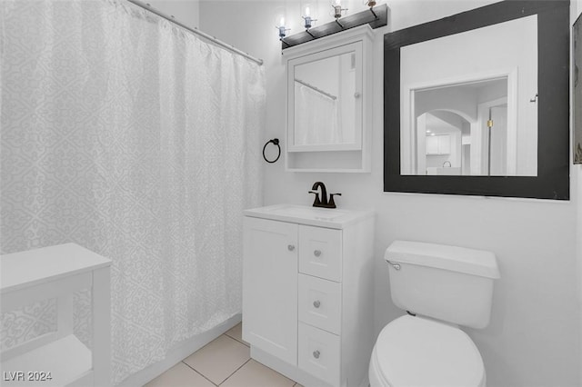 bathroom featuring tile patterned floors, vanity, and toilet