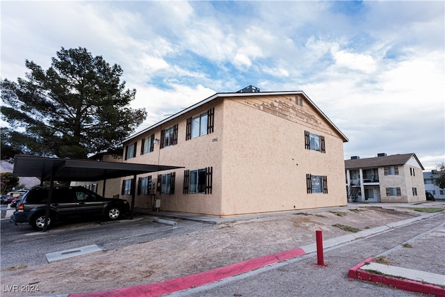 view of side of home featuring a carport