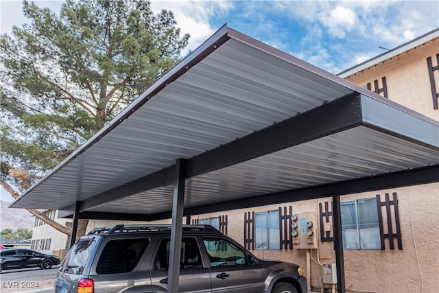 view of parking / parking lot featuring a carport