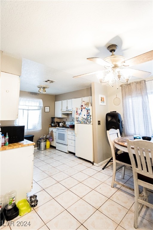 kitchen with ceiling fan, light tile patterned flooring, white appliances, and white cabinetry