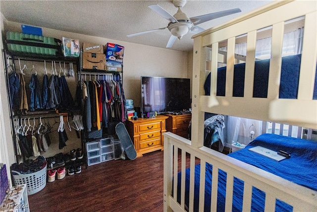 bedroom featuring ceiling fan, a closet, dark hardwood / wood-style floors, and a textured ceiling