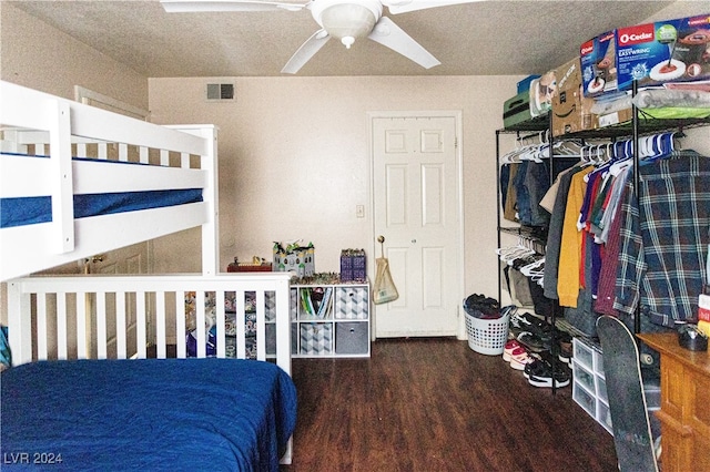 bedroom featuring ceiling fan, hardwood / wood-style flooring, and a textured ceiling